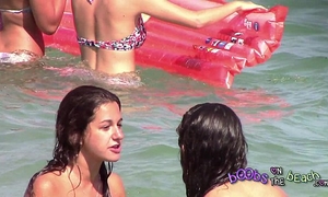 Two italian beauties playing below the water on the topless beach